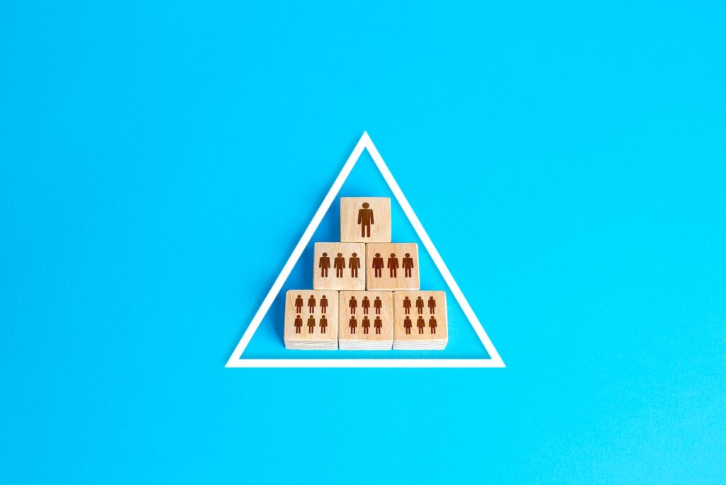 Blocks pyramid symbolizes the hierarchy of society / company organization model. Conformism system